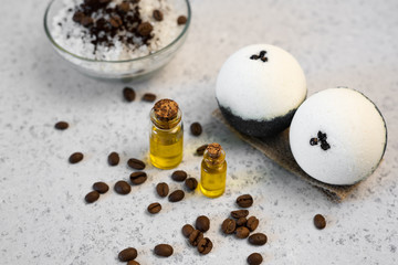 Aromatherapy and spa concept. Spa salt with coffee scent near soap, spa oil and loofah on white background top view