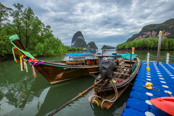 The background of the jetty, the waterfront village community and the wooden bridge overlooking the mangrove forest, is the beauty of nature, seen during travel.
