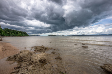 The background of a cloudy sky, colorful like a storm, and rain later, with blurring of wind and sea together, is a phenomenon that occurs naturally.
