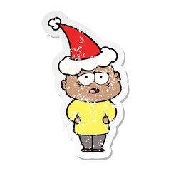 distressed sticker cartoon of a tired bald man wearing santa hat