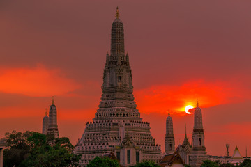 Fototapeta na wymiar Twilight wallpaper in the evening,the sun going back to the horizon,Wat Arun Ratchawaramaram is a temple along the ChaoPhraya River is an important place and a beautiful tourist destination in Bangkok