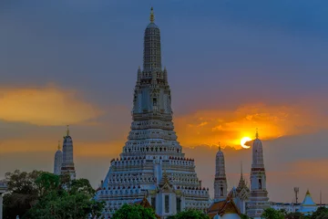 Fotobehang Twilight wallpaper in the evening,the sun going back to the horizon,Wat Arun Ratchawaramaram is a temple along the ChaoPhraya River is an important place and a beautiful tourist destination in Bangkok © bangprik