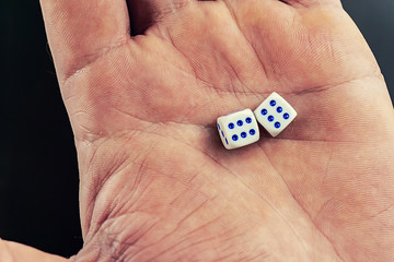 dice in a man's hand