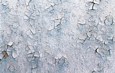 Old wooden background with remains of pieces of scraps of old paint on wood. Texture of an old tree, board with paint, vintage background peeling paint. 