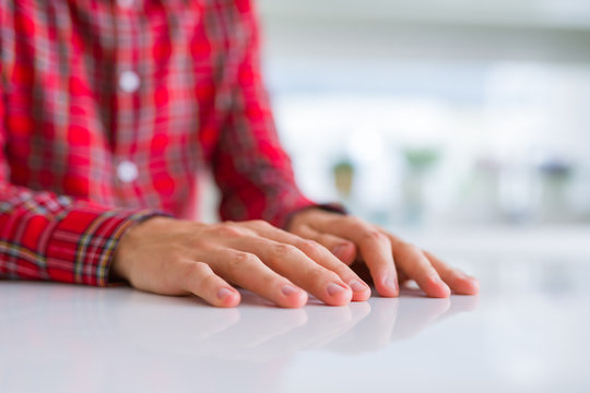 Close up of man hands with palms together over white table