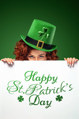 st patrick;s day. Young sexy oktoberfest waitress on green background with banner for copy space