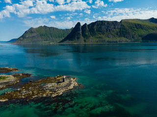 Gimsoy lighthouse on sea rocks, Lofoten Norway