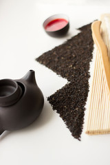 Oolong tea fresh red tea in a cup and black tea scattered in the shape of mountains