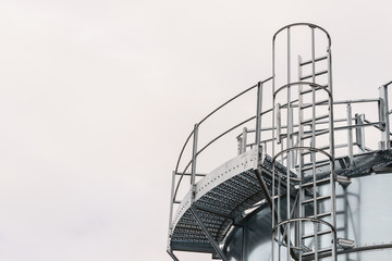 Industrial metal ladder with round railing