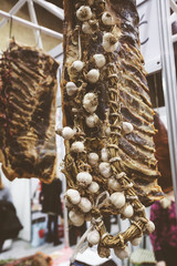 garlic wreath hanging over smoked meat