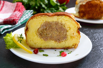 Potato balls with minced meat in deep fat, baked with mozzarella. Cut, close-up