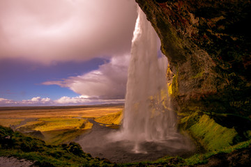 Fototapeta na wymiar View of a waterfall in Iceland. Water flows from top to bottom.