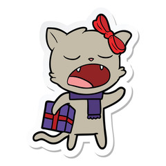 sticker of a cartoon cat with christmas present