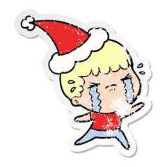 distressed sticker cartoon of a man crying wearing santa hat