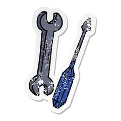 distressed sticker cartoon doodle of a spanner and a screwdriver