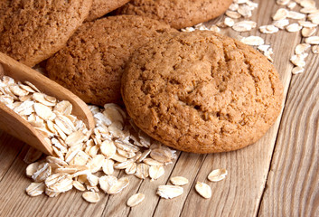 Oatmeal cookies with oat flakes with a wooden spoon. healthy food. on a wooden table