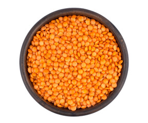 Red lentils in plate isolated on white background
