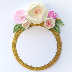 Golden round frame with a white circle in the middle framed by a floral arrangement of flowers of pastel shades and leaves. isolate on white background...