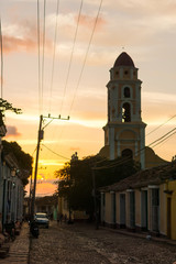 Cuban street sunset with oldtimer in Trinidad, Cuba