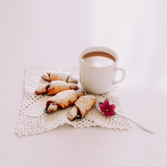 A cup of coffee with croissants on white background. Good morning. Breakfast. Flat lay