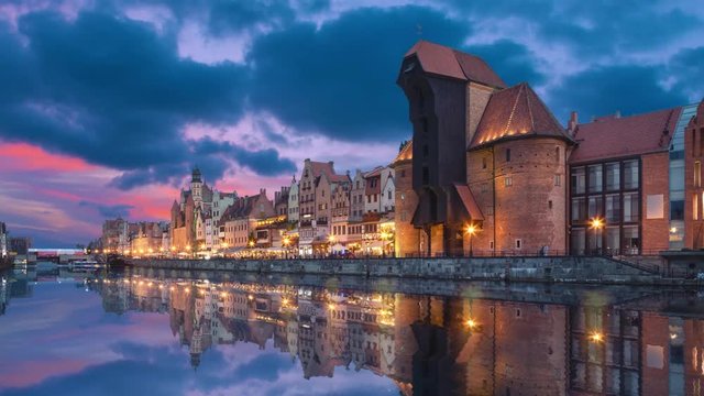 Gdansk, Poland. Historic port crane reflecting in water at dusk (static image with animated sky and water)