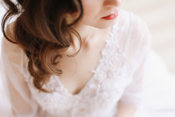  Girl with red lips in profile. Close-up portrait of a young woman. Wedding details. Morning of the bride.