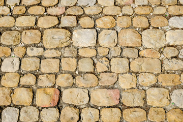 Road surface paved with cobblestone, Italy. Texture for design and backgrounds.