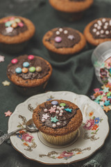 Chocolate muffin on antique porcelain plate. Birthday party, pastry dessert concept