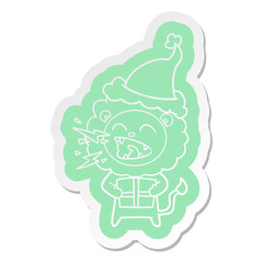 cartoon  sticker of a roaring lion with gift wearing santa hat