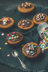Chocolate muffins with topping, top view flat lay, dark background