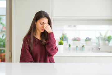 Young beautiful woman at home tired rubbing nose and eyes feeling fatigue and headache. Stress and frustration concept.