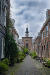 Fototapeta na wymiar A street with a view of the Nieuwe Kerk in Haarlem, the Netherlands 