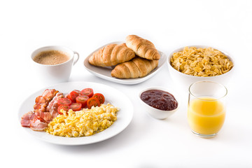 Breakfast with scrambled eggs, bacon, tomatoes,coffee,orange juice ,croissant and corn flakes isolated on white background