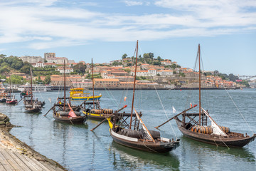 Fototapeta na wymiar Typical portuguese wooden boats, called -barcos rabelos- used in the past to transport the famous port wine towards the cellars of the city