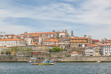 View of Old Porto, Oporto city, colorful Ribeira traditional wine boats in Douro river from Vila Nova de Gaia