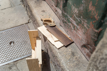 Handsaw and wooden box on a street of an old city