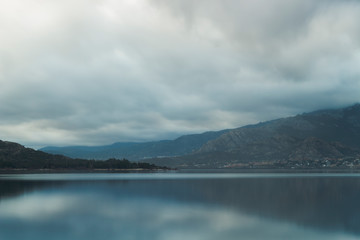 Beautiful reflections of clouds and mountains in the water of a lake