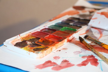 palette with paints and brushes