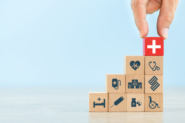 Health Insurance Concept,hand arranging wood block stacking with icon healthcare medical.