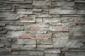 Texture of gray stone wall background.Slate Stone wall brown texture in the park.