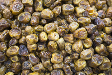 Dried dates fruits as background, sweet and tasty desert from orient