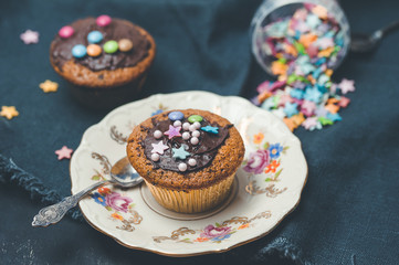 Chocolate muffin on antique porcelain plate. Birthday party, pastry dessert concept