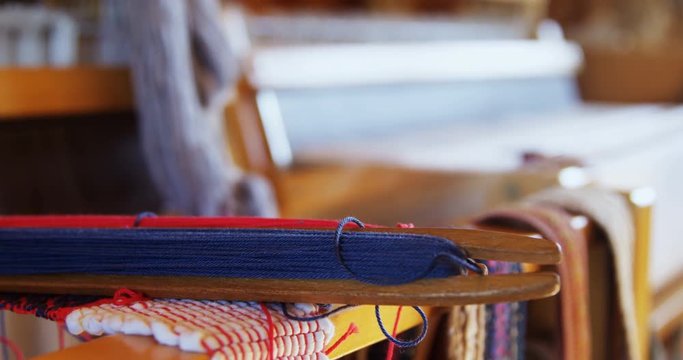 Hand loom machine and loom shuttle in a empty workshop 4k