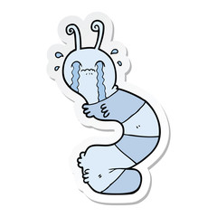 sticker of a cartoon crying caterpillar