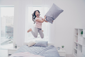 Full length body size view photo funky careless she her little girl jumping high bed  playful curly...