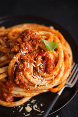 Tasty pasta bolognese with cheese and basil