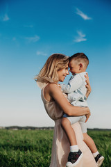 Fototapeta premium Young mother and her adorable little son outdoor