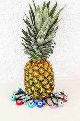 evil eye bracelets advertisement with exotic pineapple fruit - traditional greek jewelry