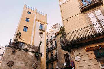 stone houses with balconies on quite street, barcelona, spain