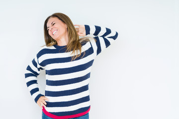 Beautiful middle age woman wearing navy sweater over isolated background stretching back, tired and relaxed, sleepy and yawning for early morning